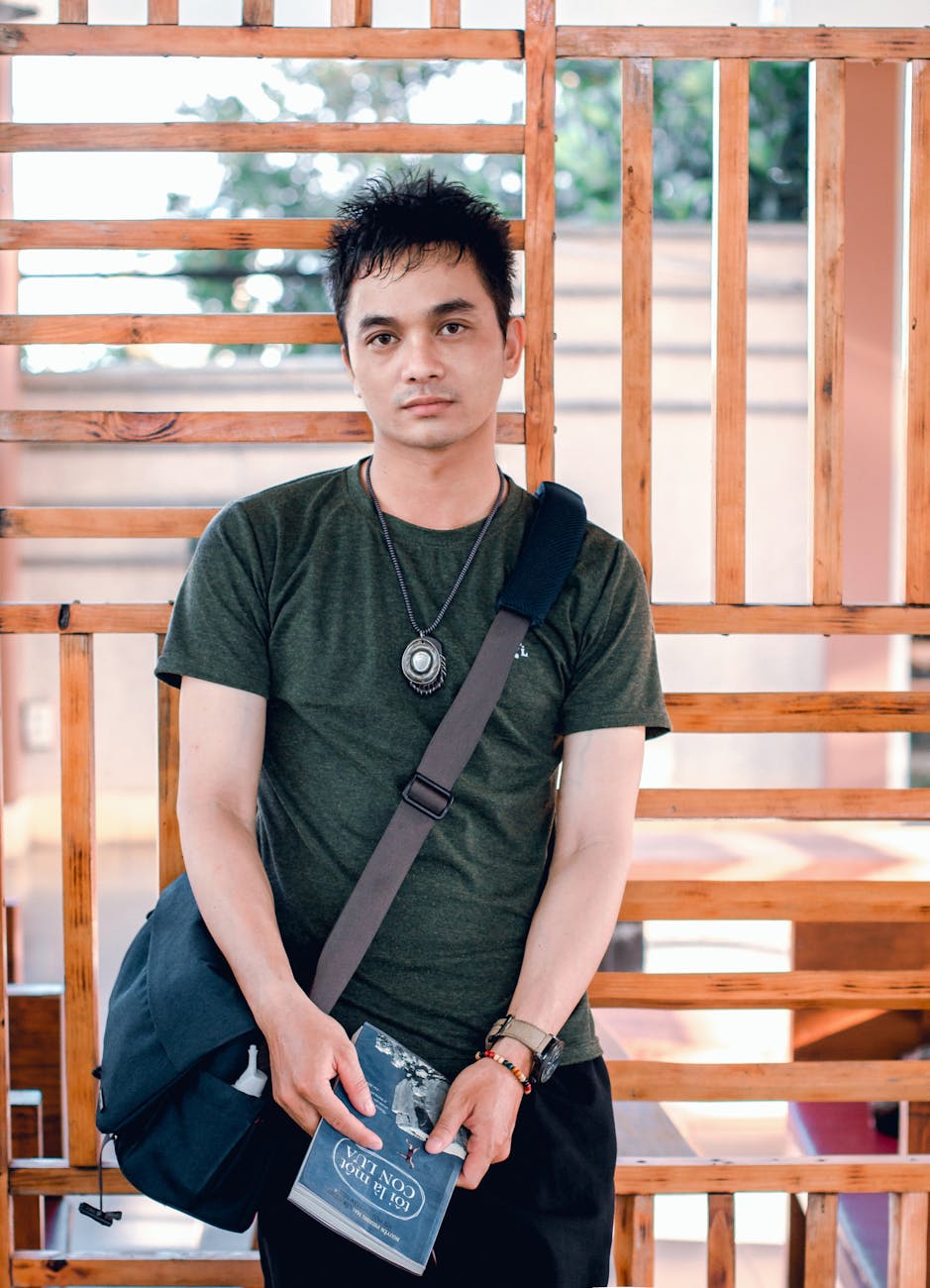 man standing near brown wooden frame