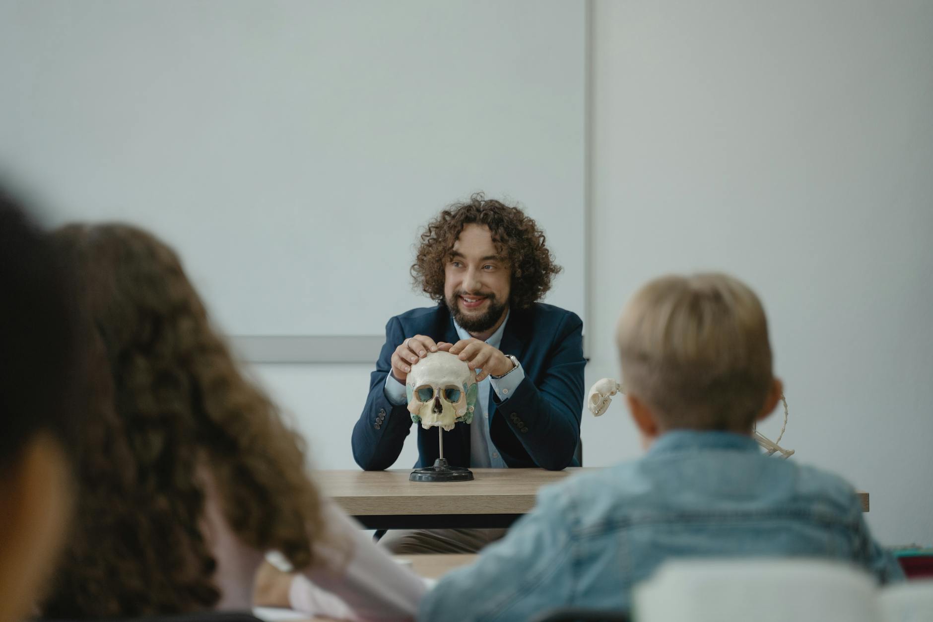 teacher showing his class a human skull