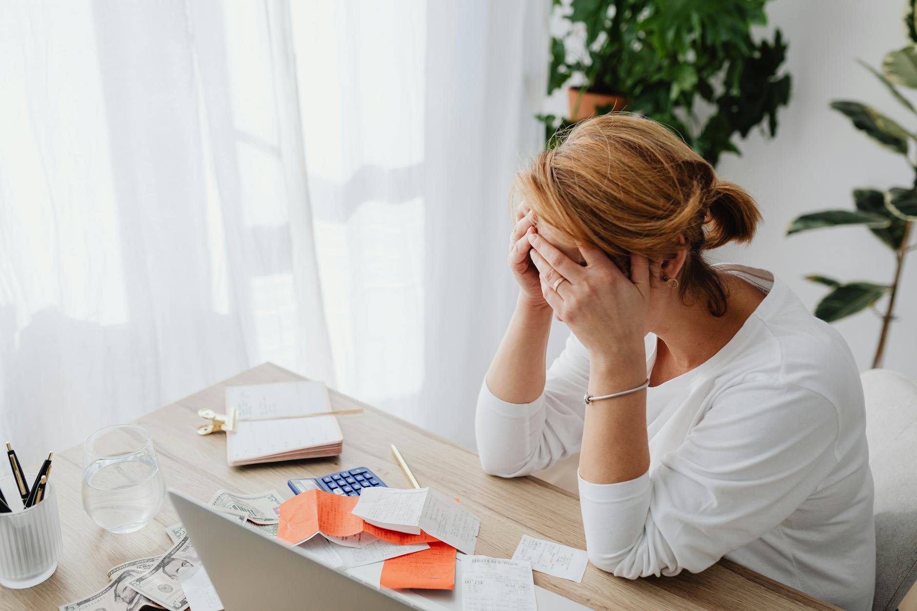 woman and receipts on desk