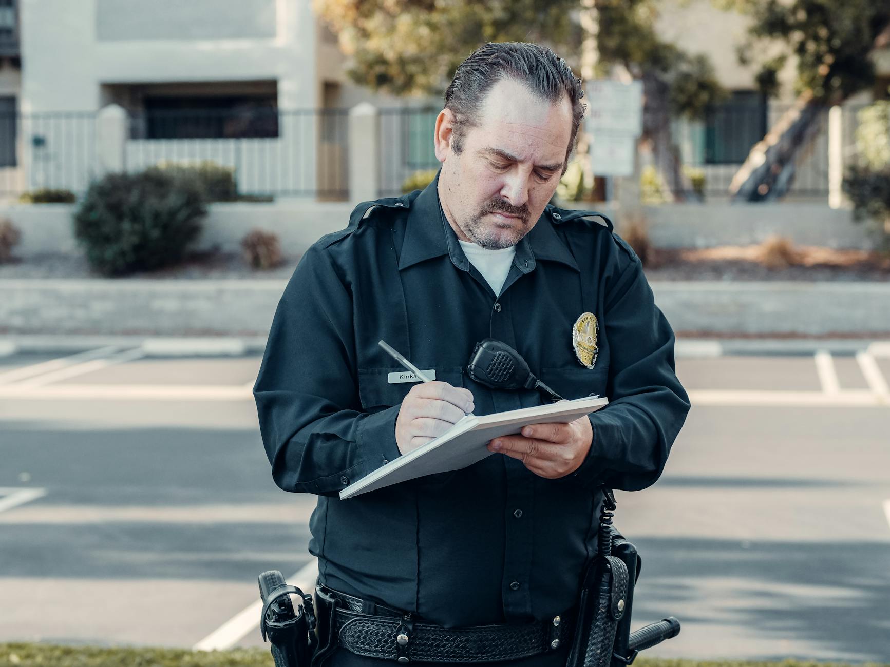 a bearded police man writing on paper