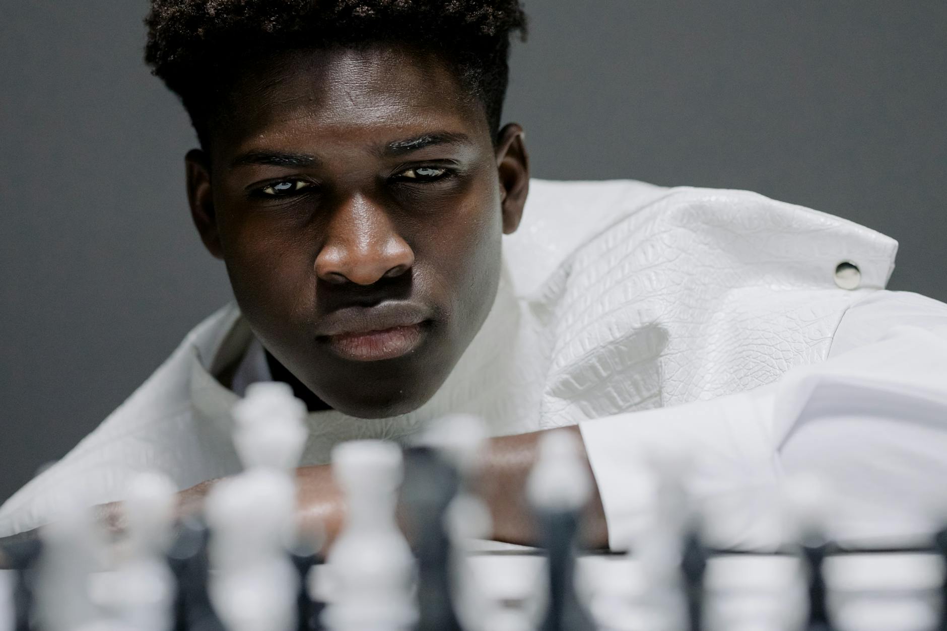 man in a white costume and white chess pieces