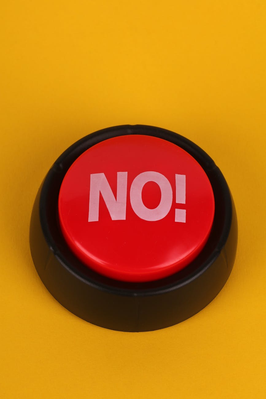 red no button on yellow bac