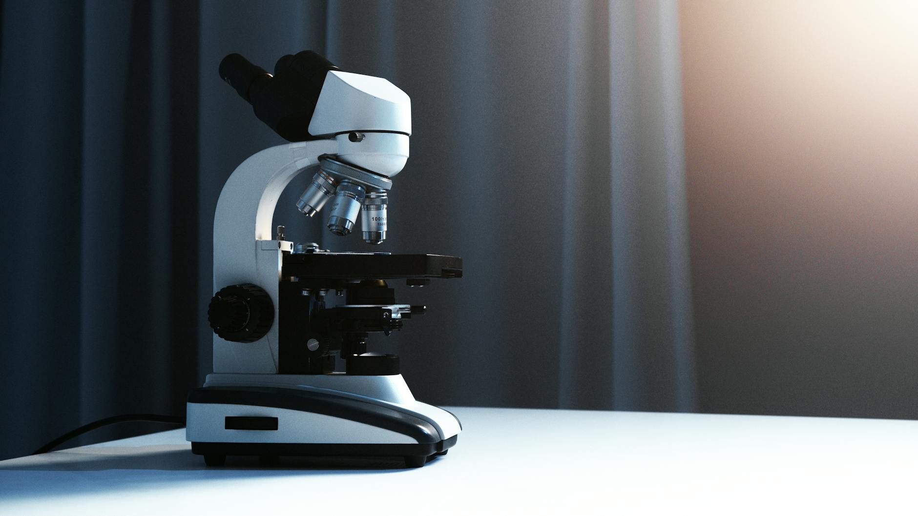 a light microscope placed on a white surface