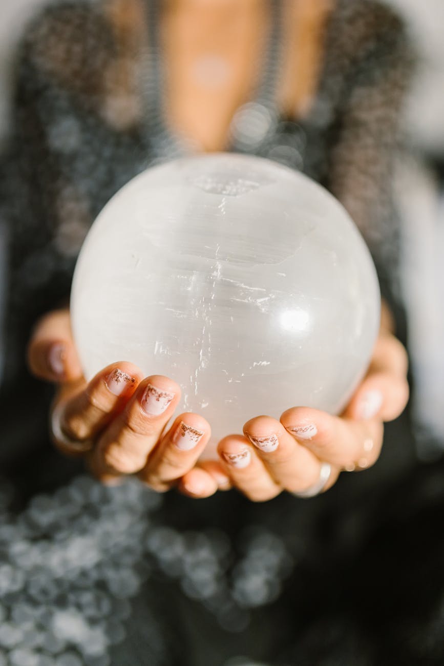 person holding white round ball