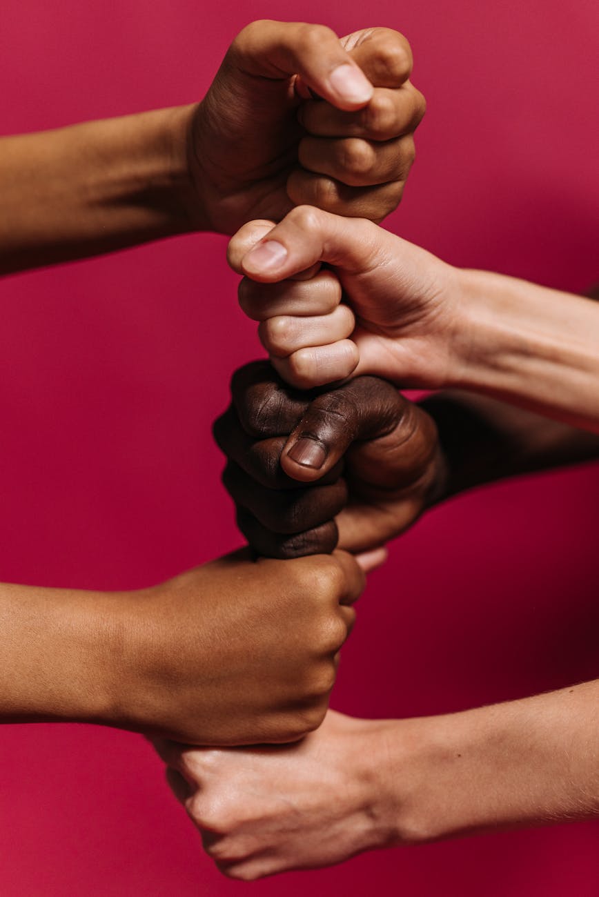 clenched fists of people on top of one and another