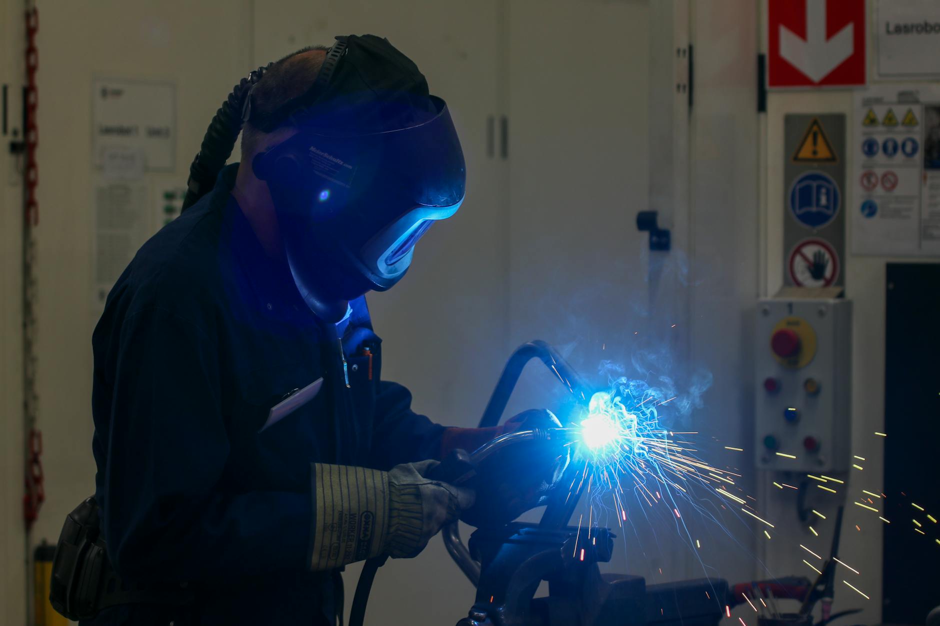 industrial welder in action with bright sparks