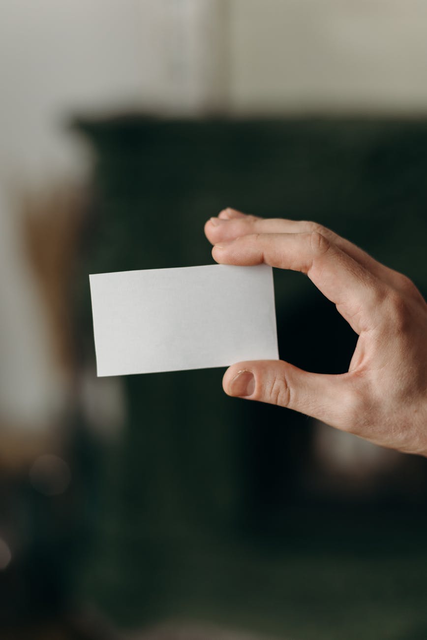 person holding white blank card