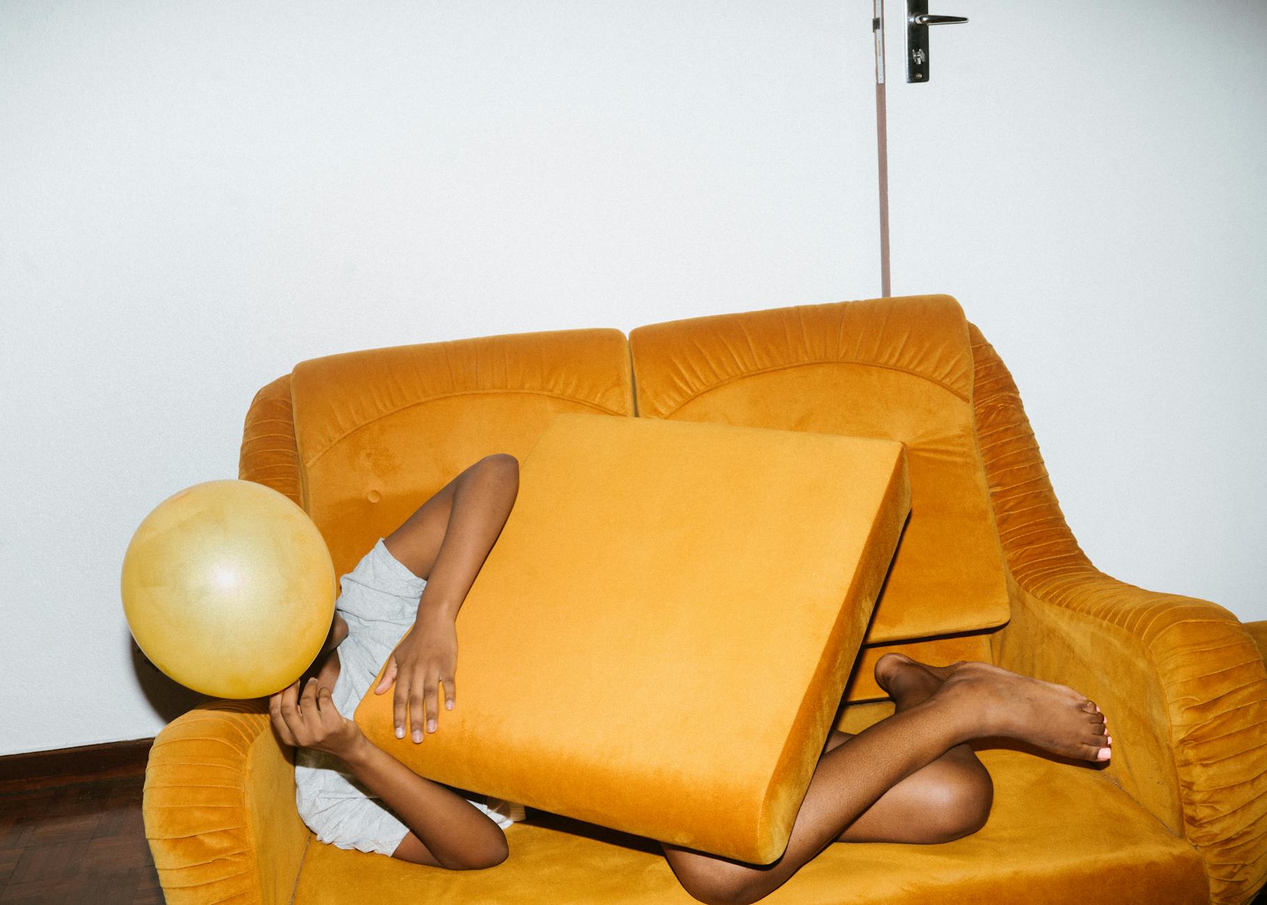 person lying on brown sofa chair