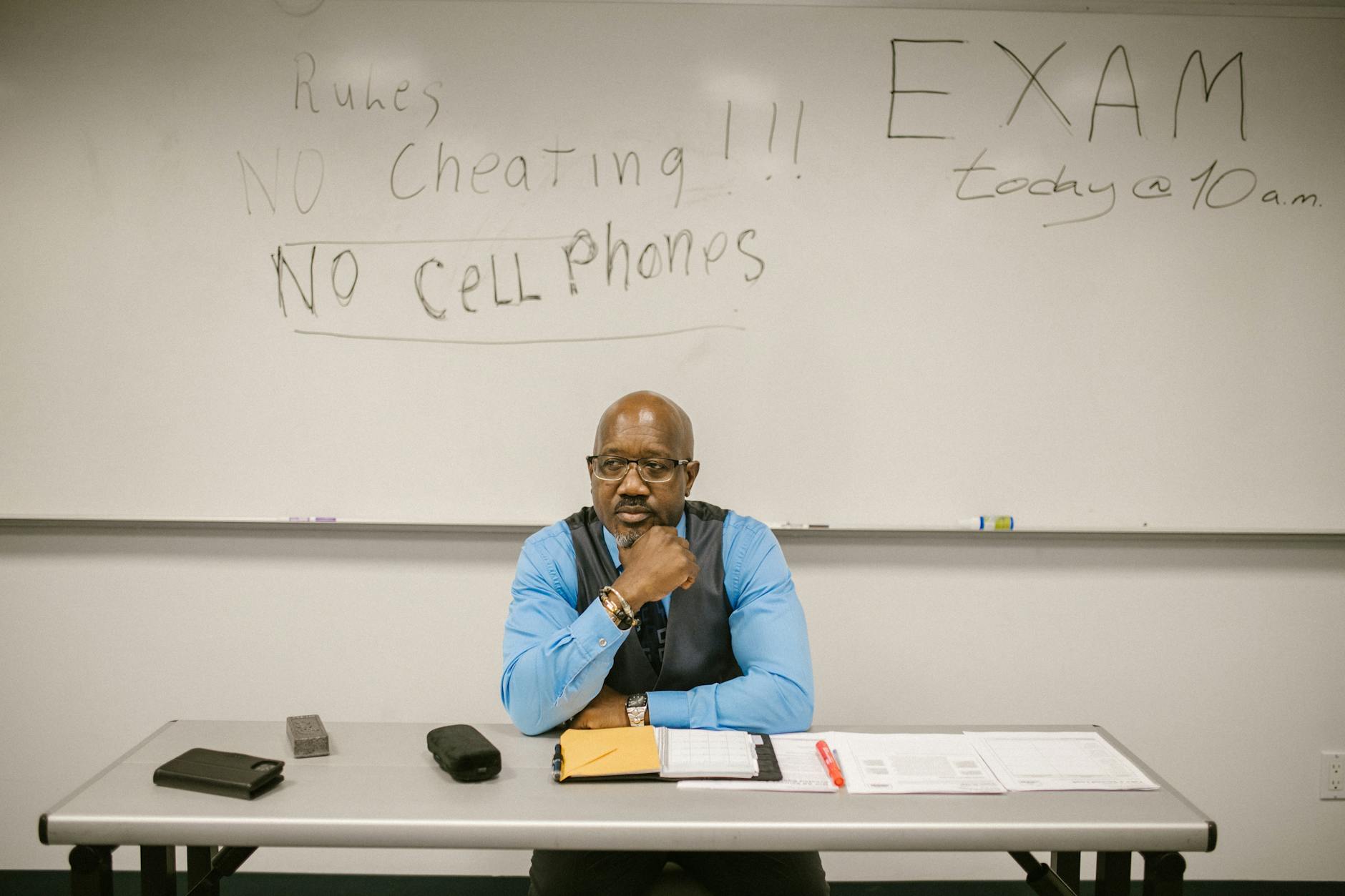 teacher sitting by his desk