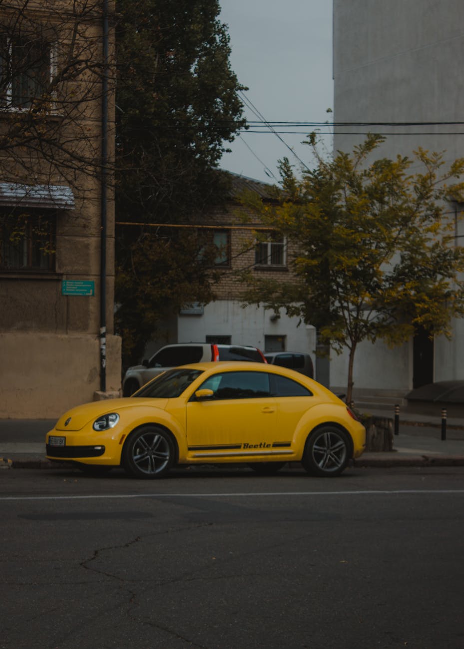 yellow car parked on roadside