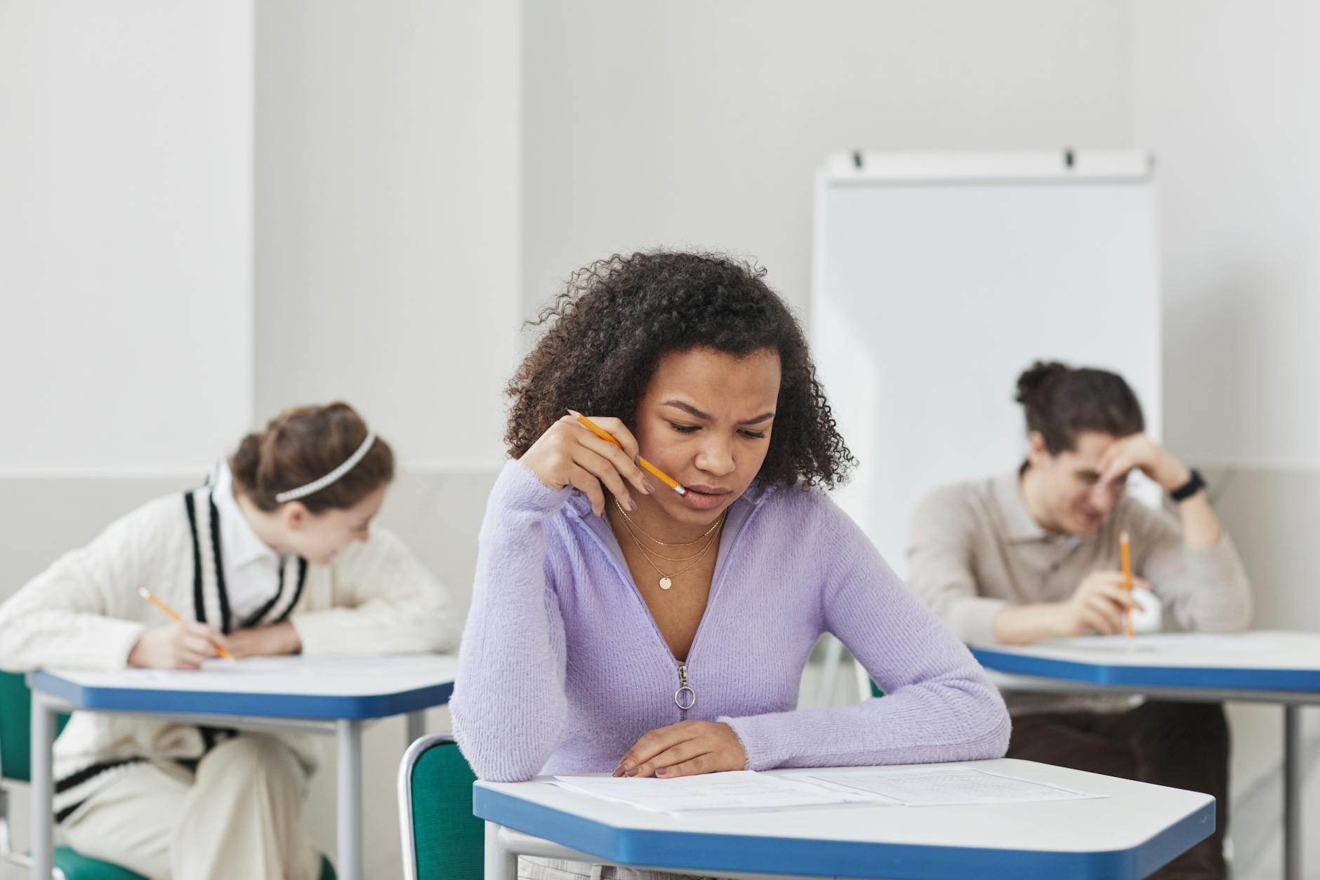 teenage girl holding a pencil