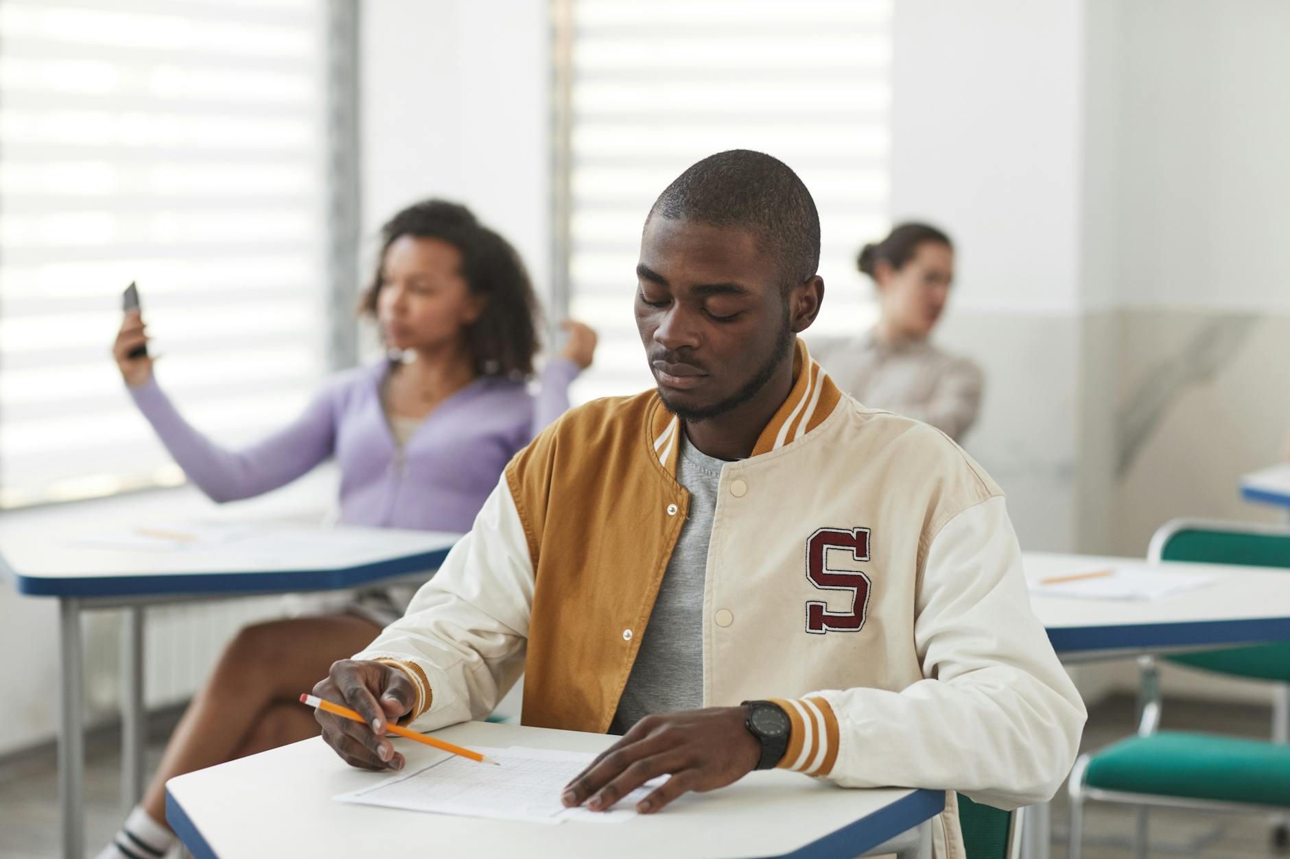 man in a varsity jacket