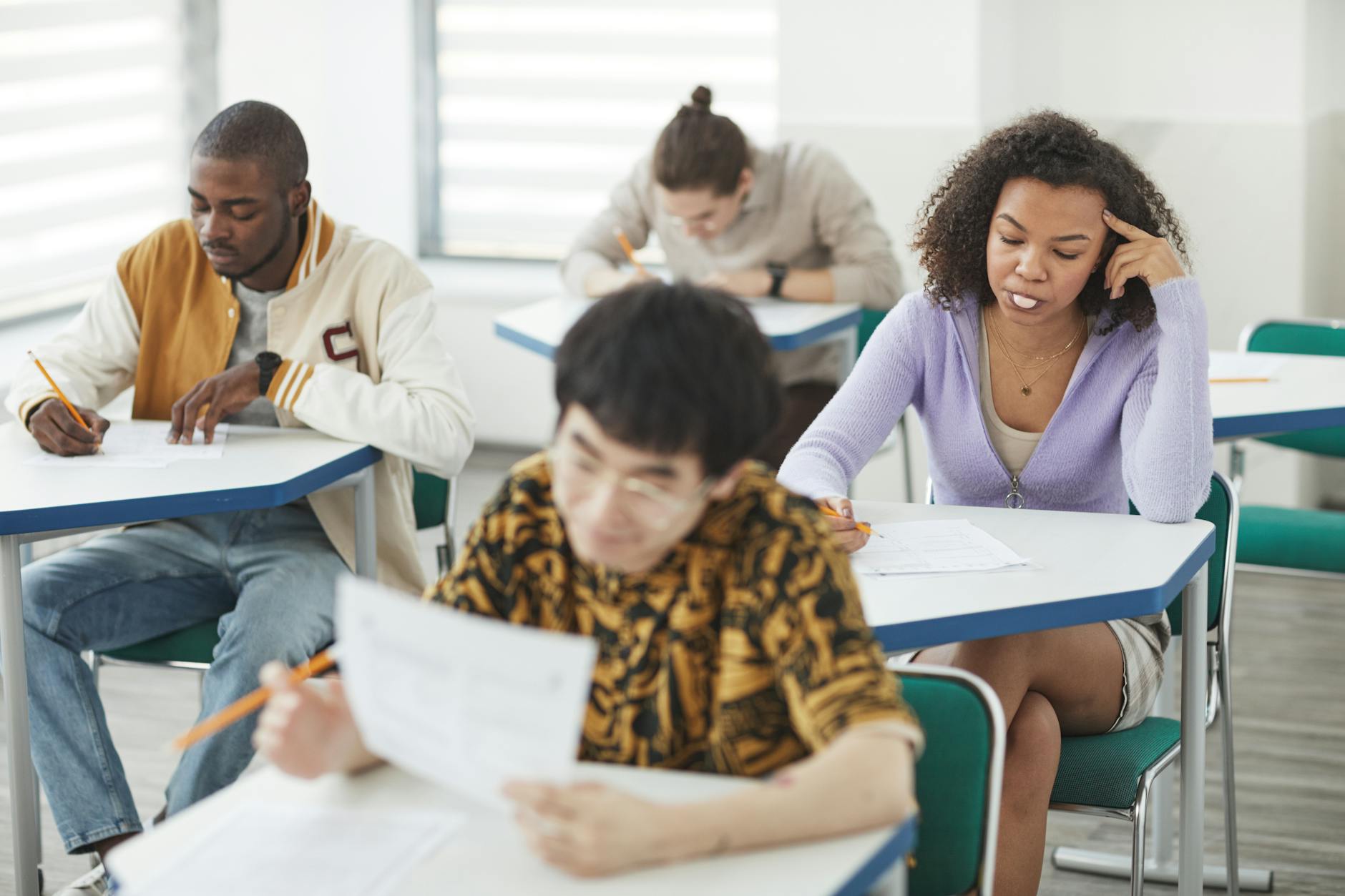 a woman blowing a gum while taking exam