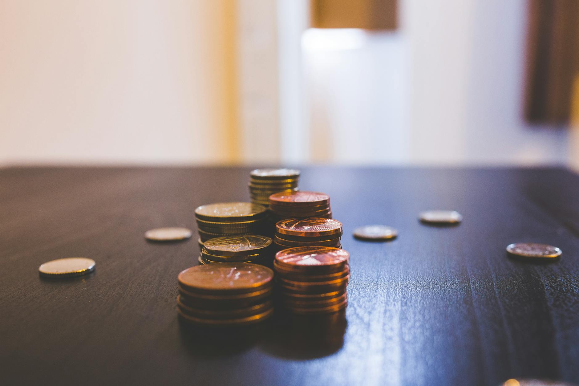 pile of brown coins on brown wooden table top