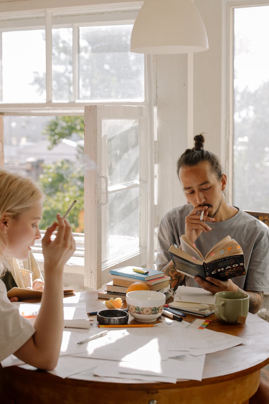 woman in white shirt sitting at table