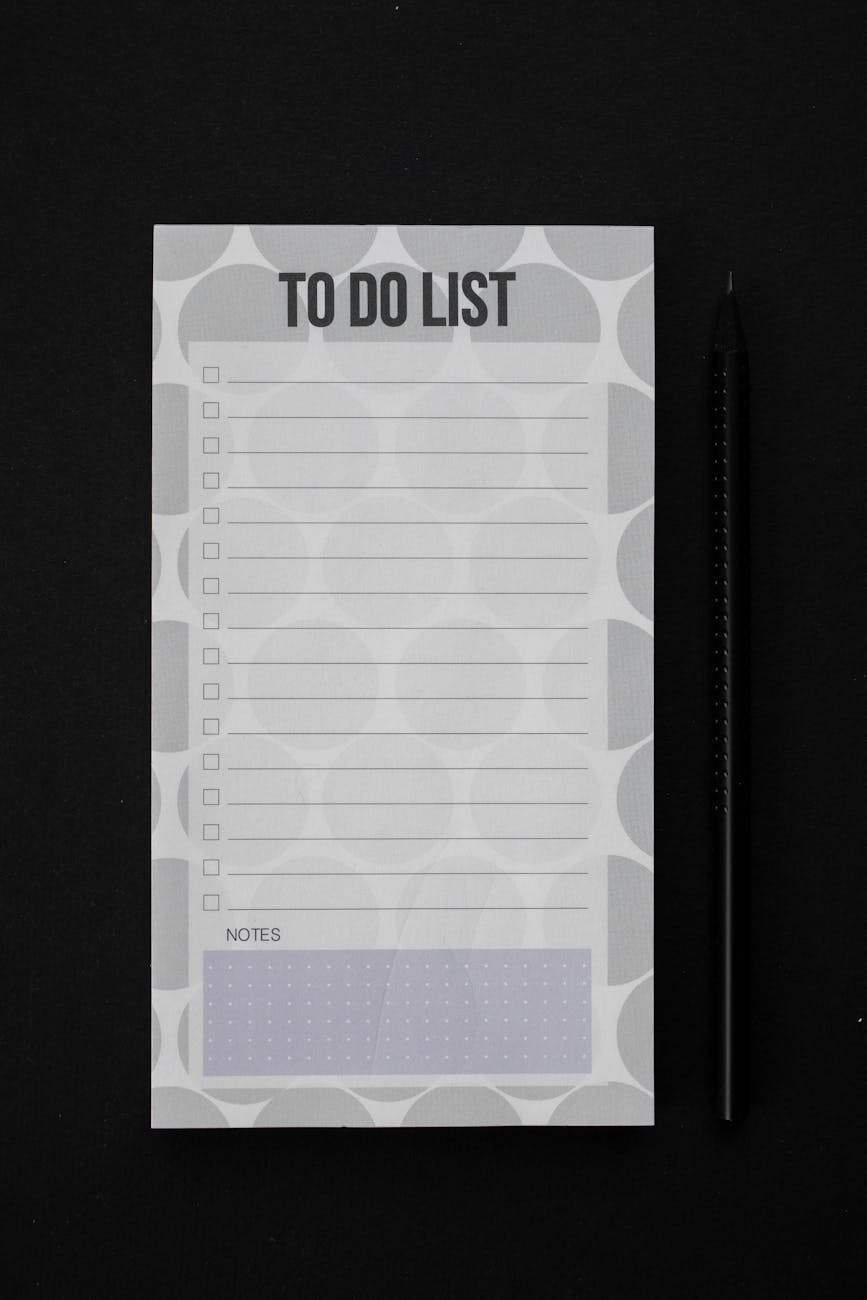 close up shot of a to do list on a black surface