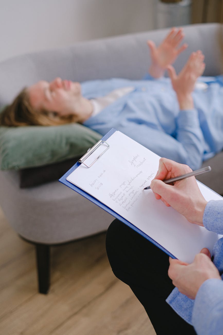 close up shot of a person interviewing a man lying down on a couch