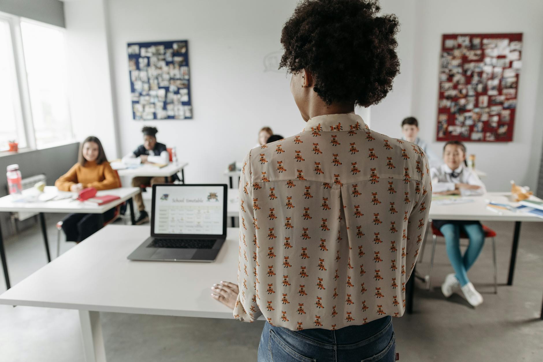 a teacher standing in front of her students