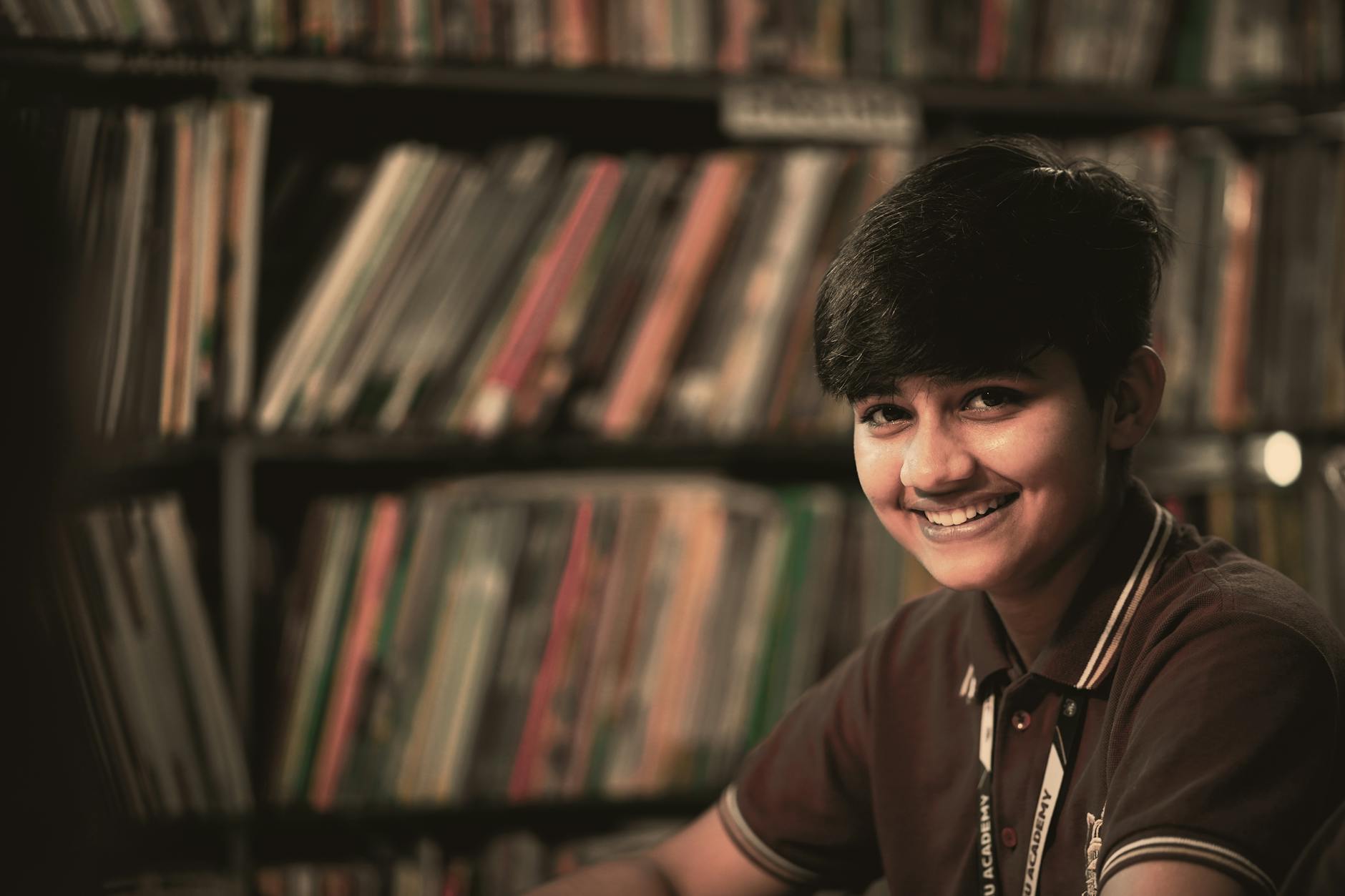 smiling teenager in library setting