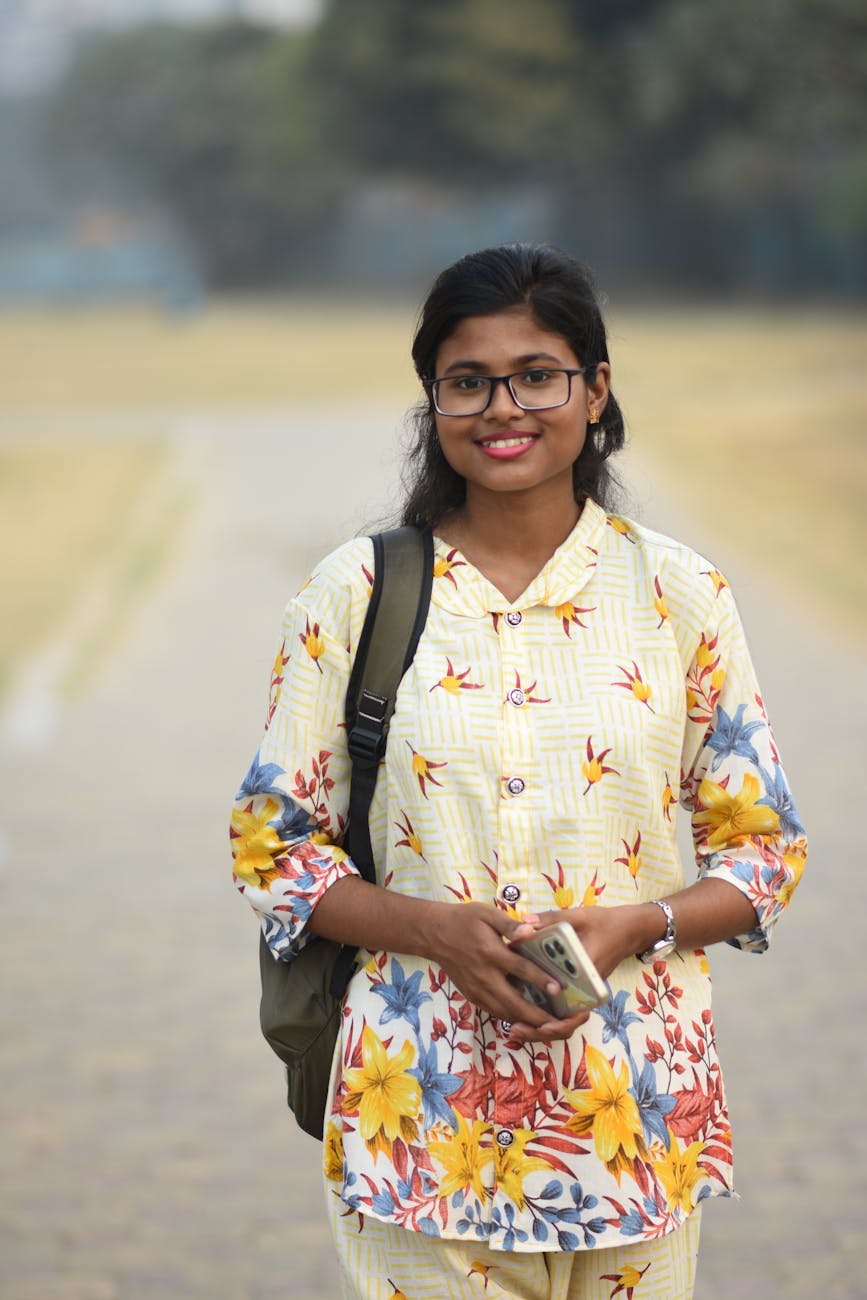 young south asian woman smiling outdoors in kolkata