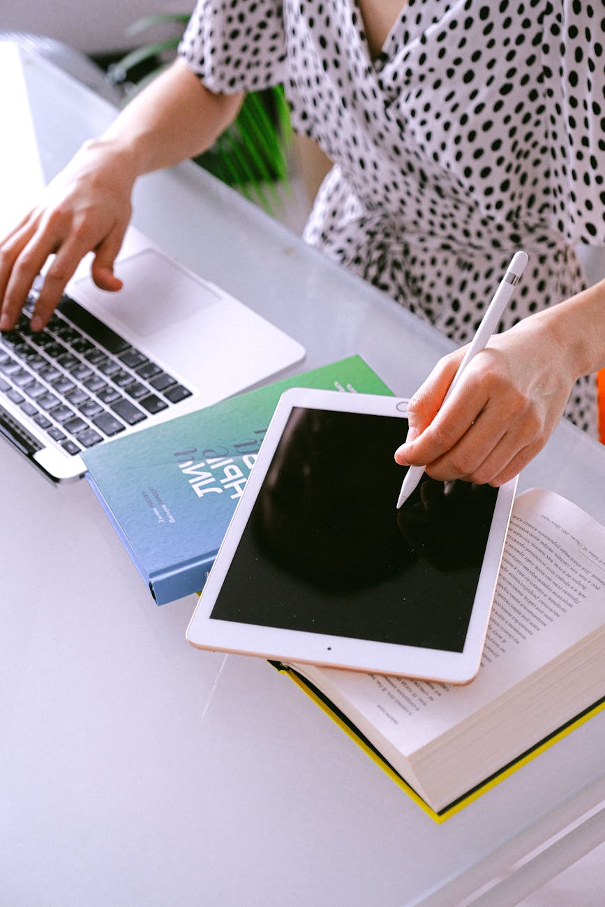 person using laptop and tablet