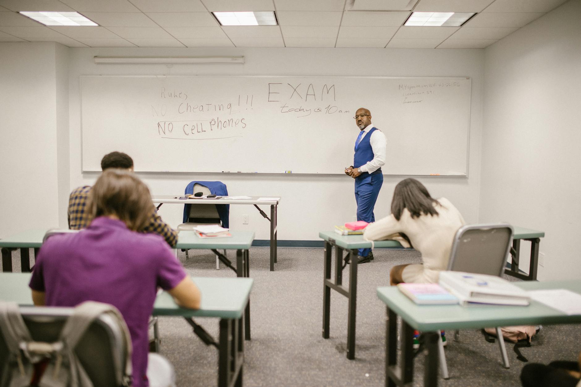 teacher proctoring his students during an examination