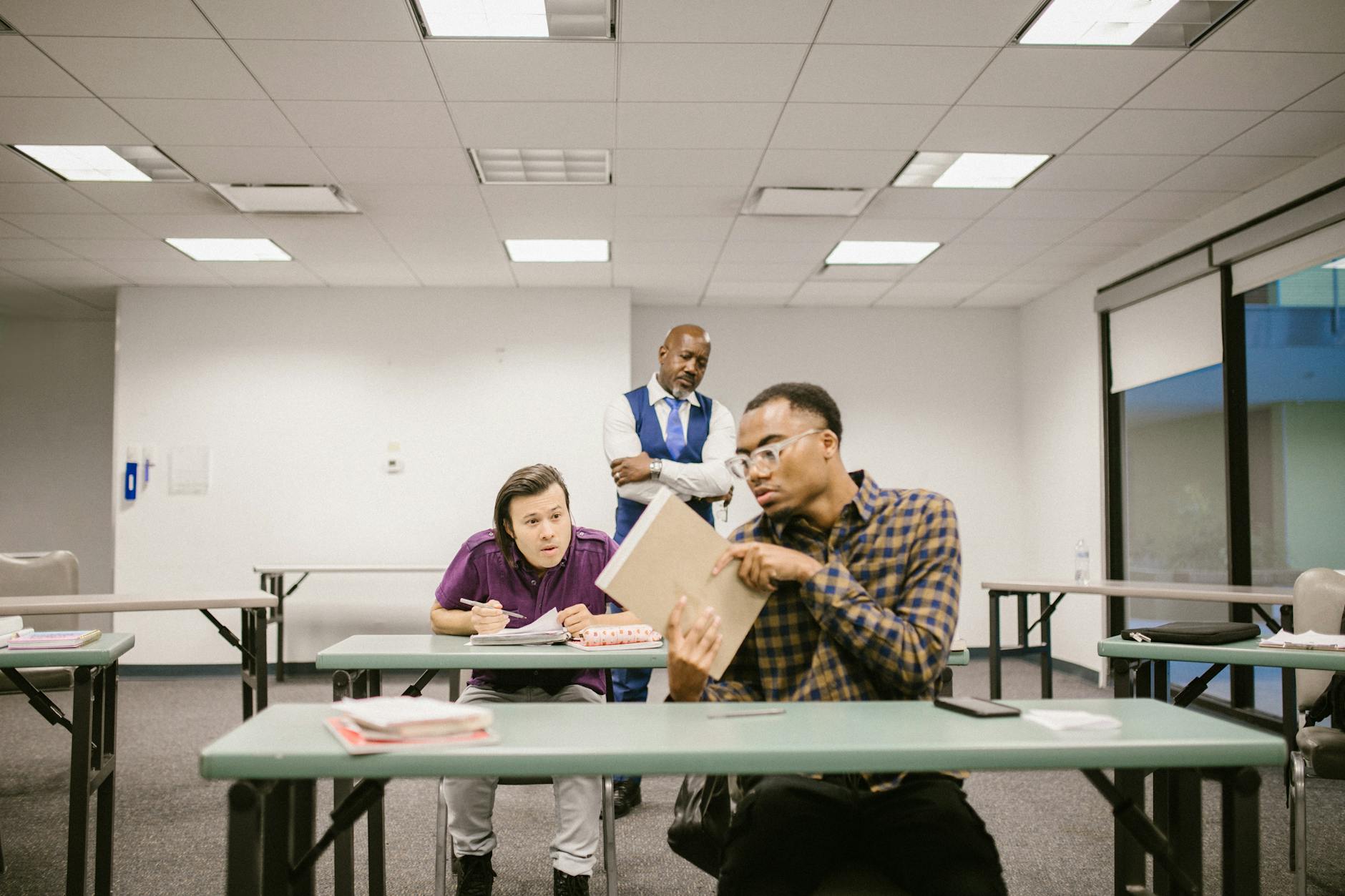 teacher proctoring his students during an examination