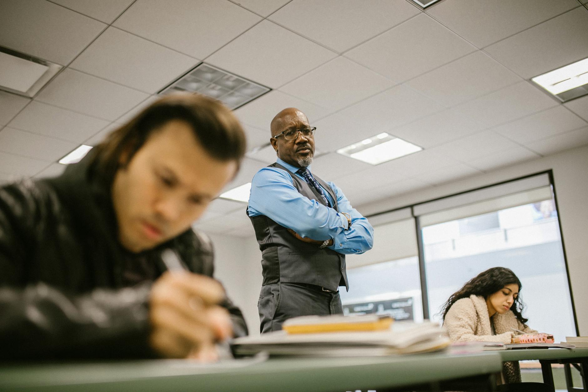 teacher proctoring his students during an examination