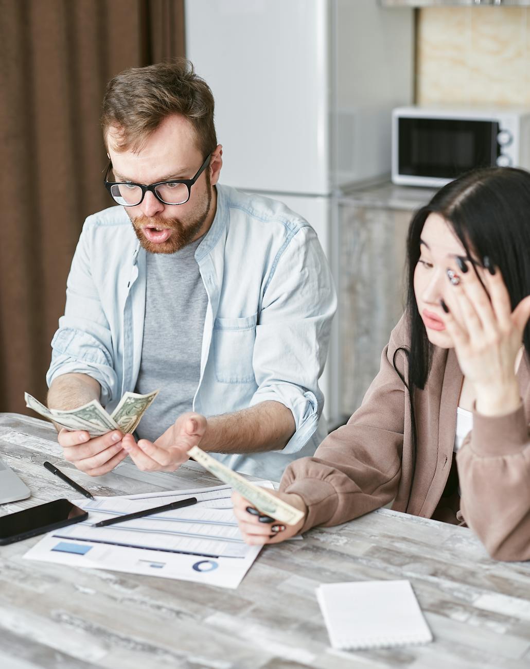 man and woman holding a money