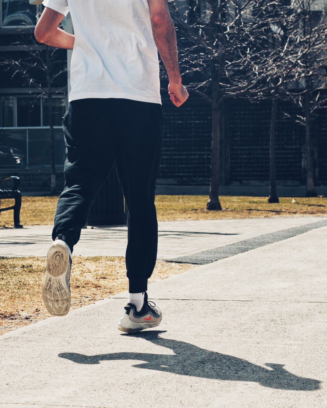 backview of person running on a pavement