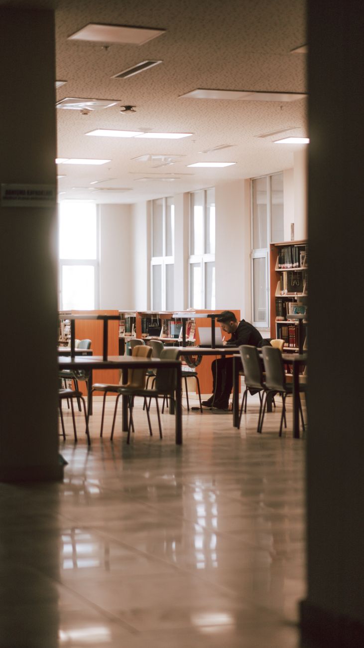 man sitting at library and studying