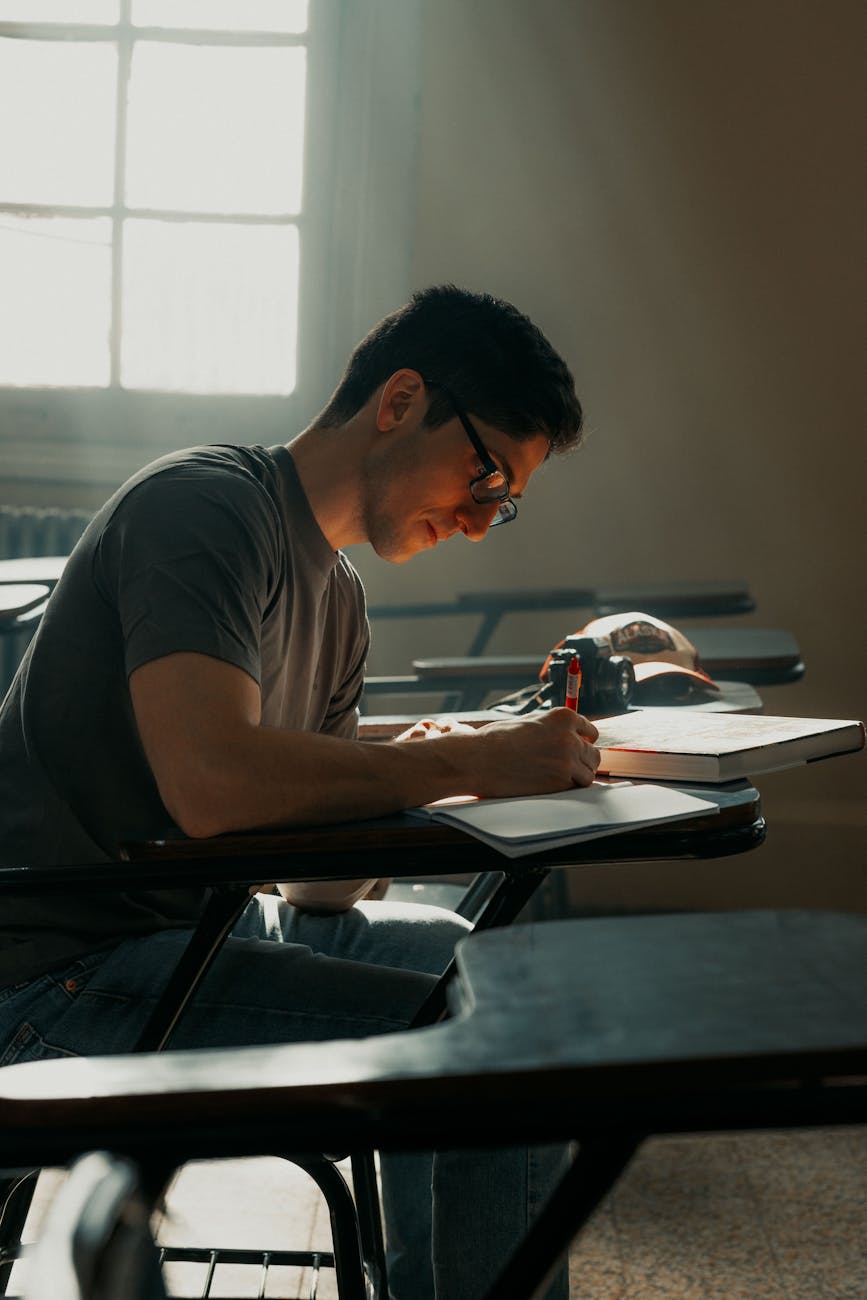 focused student studying in sunlit classroom