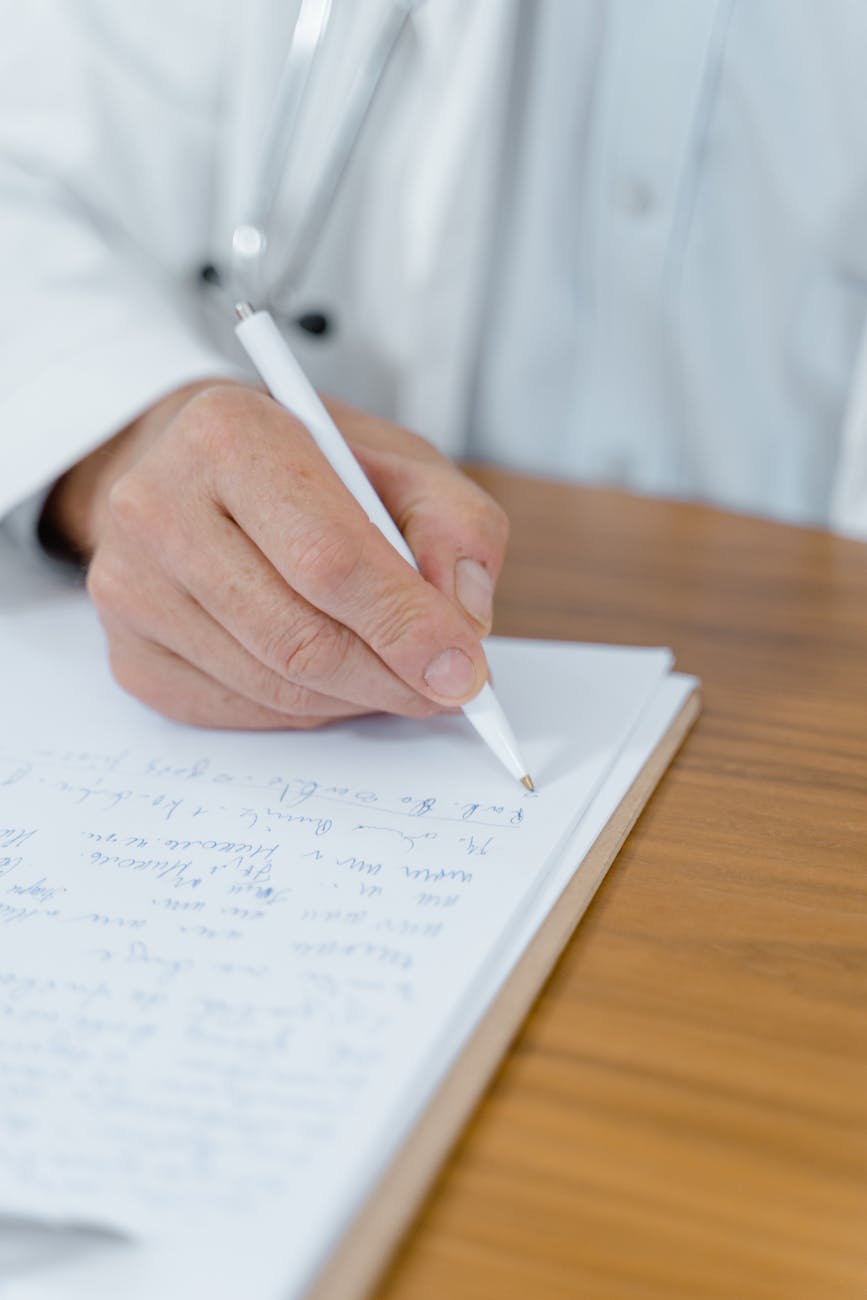 close up shot of person writing on white paper