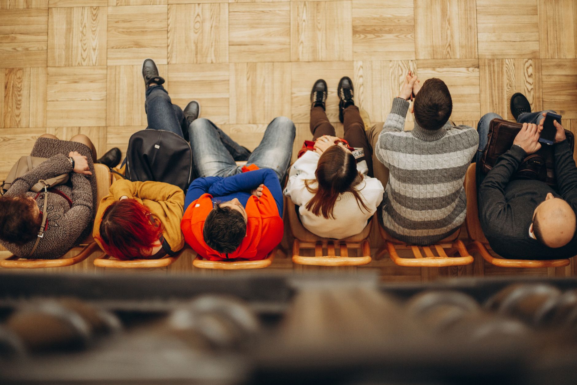 people sitting in a row of chairs