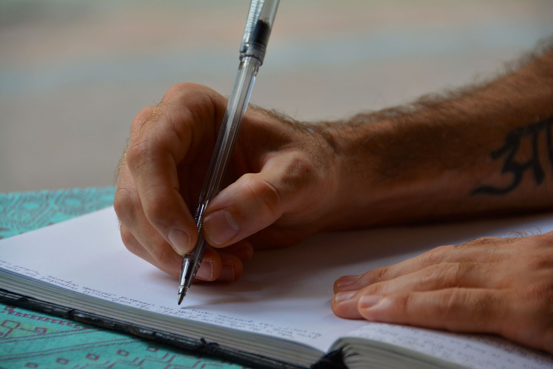 man writing in a book