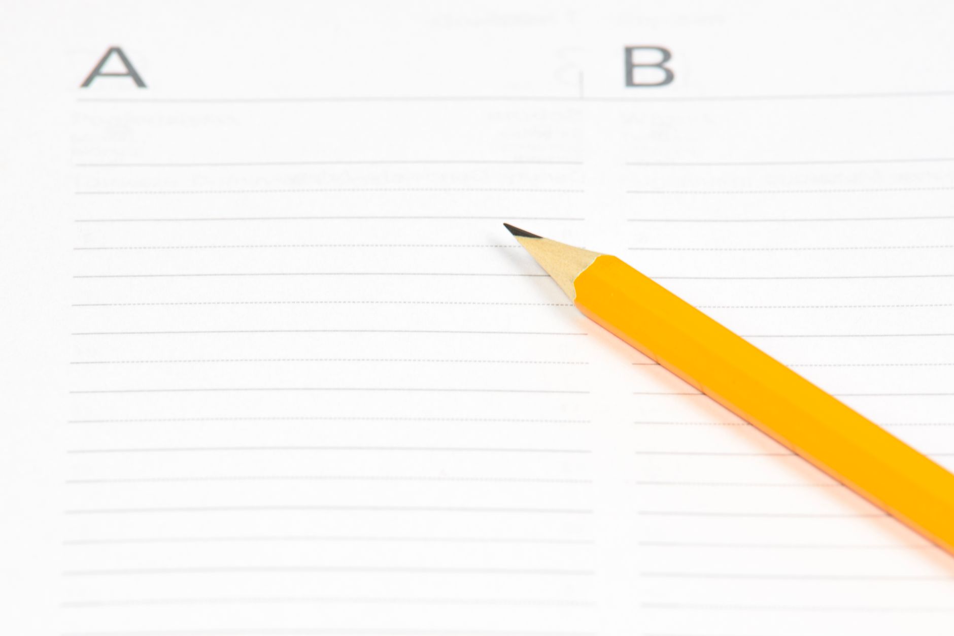 yellow pencil on white ruled paper