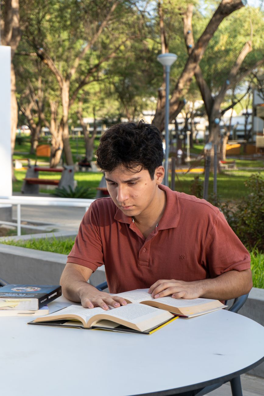 young man studying outdoors at university campus
