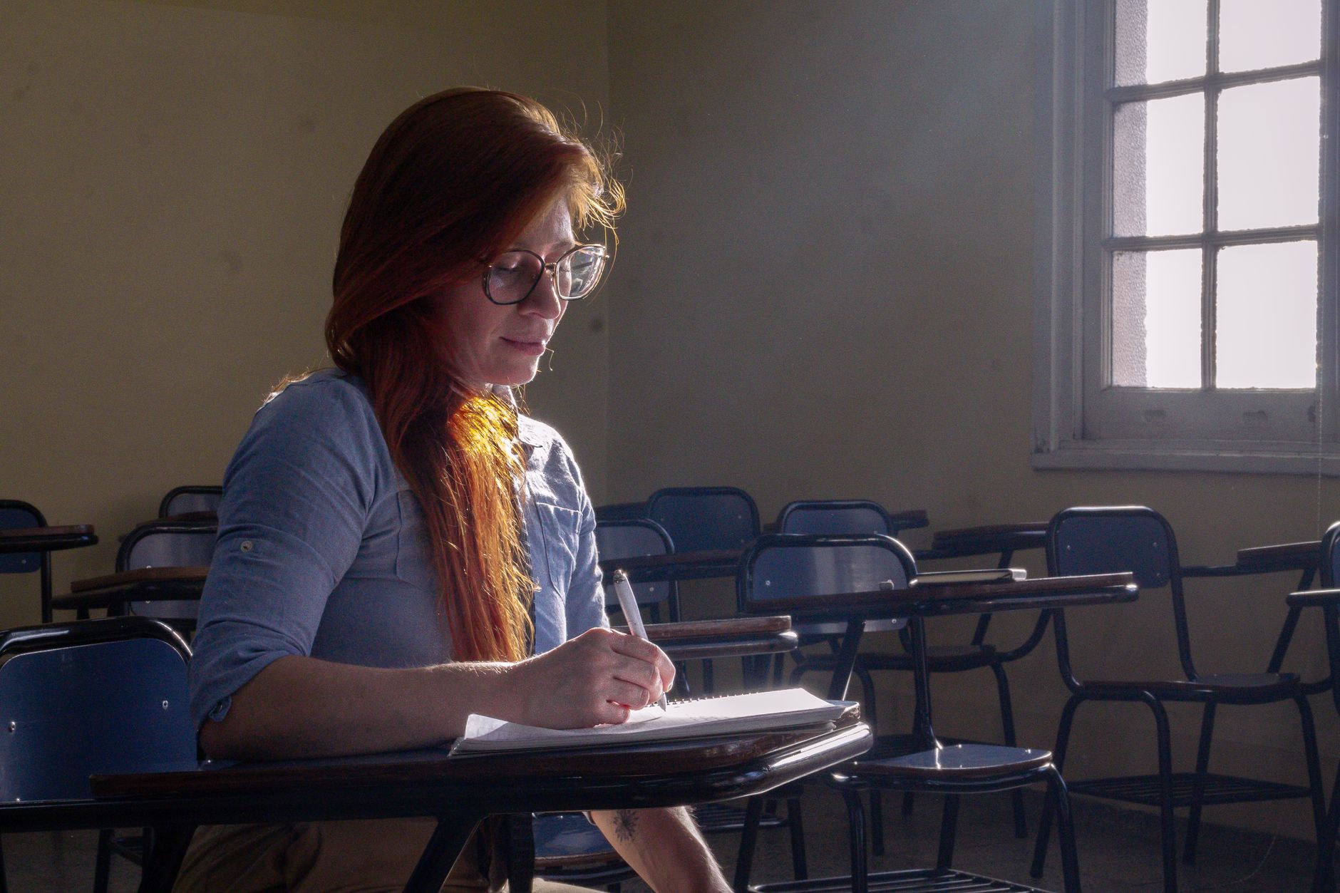 university student studying in classroom with natural light