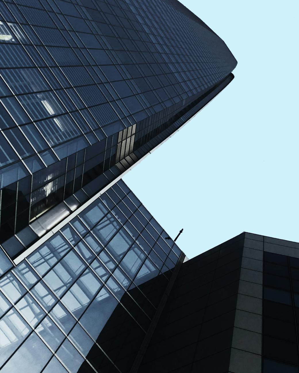 low angle shot of buildings with glass windows