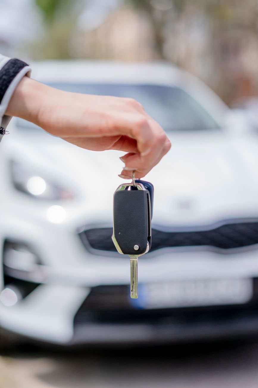 person holding a car key