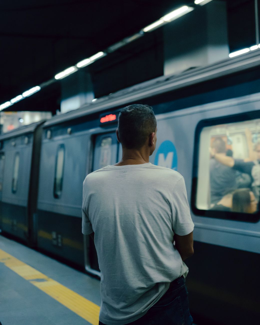 man standing in a metro station
