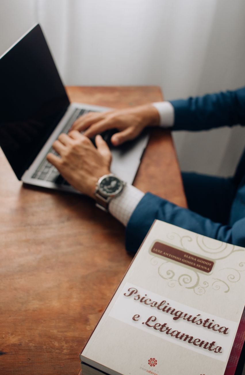 a man is sitting at a desk with a laptop