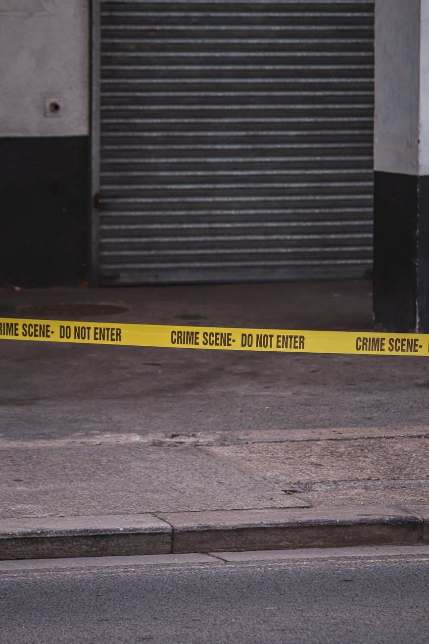 a police tape is placed on the ground near a building