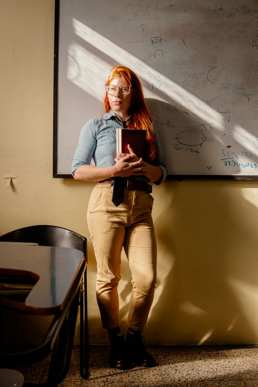 young teacher standing in classroom ambiance