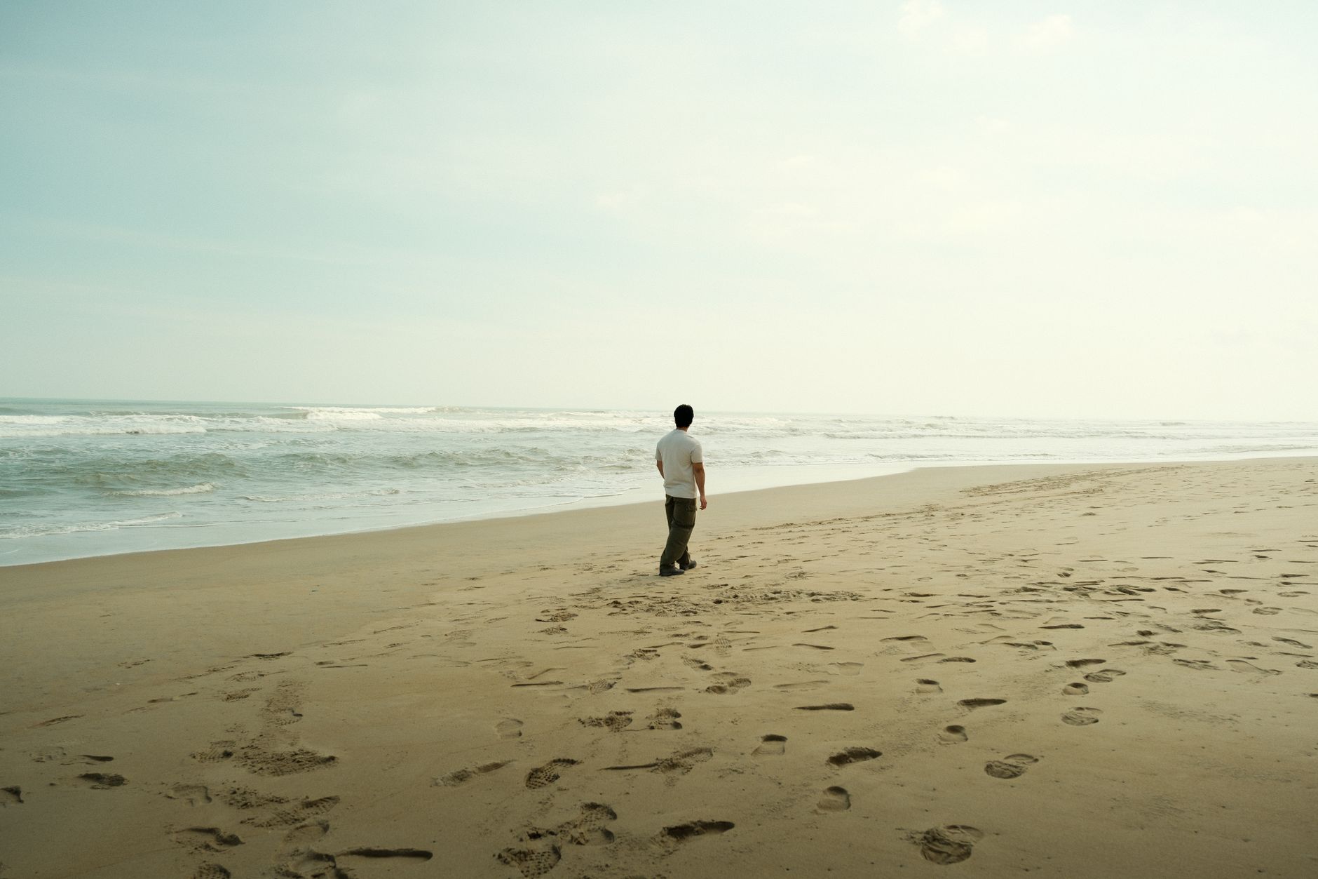 solitary walk on a serene sandy beach
