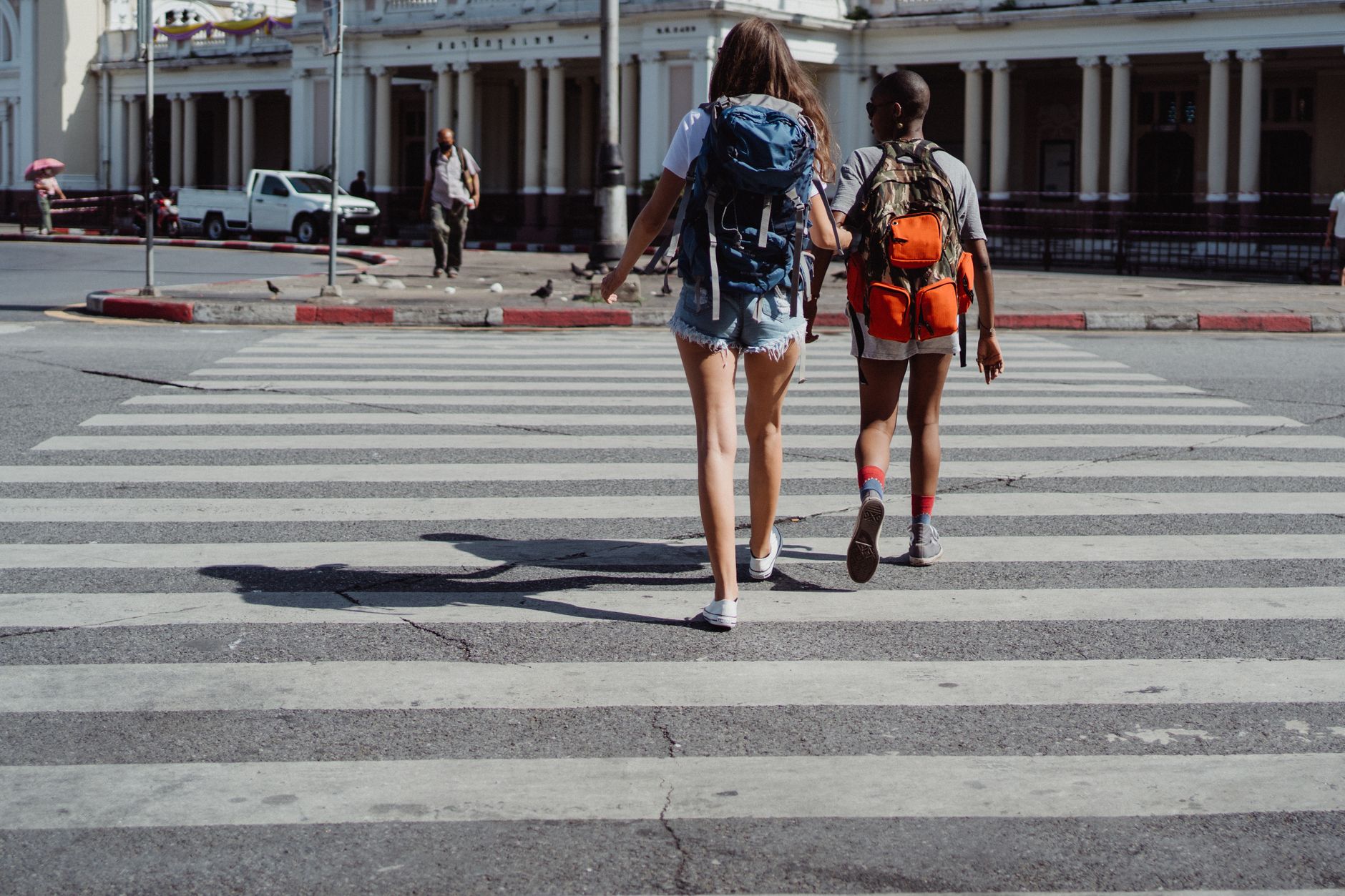 two friends crossing the pedestrian lane