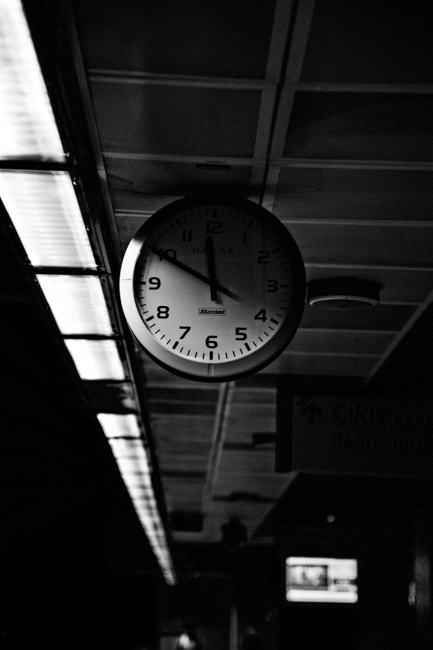 grayscale photo of round analog wall clock