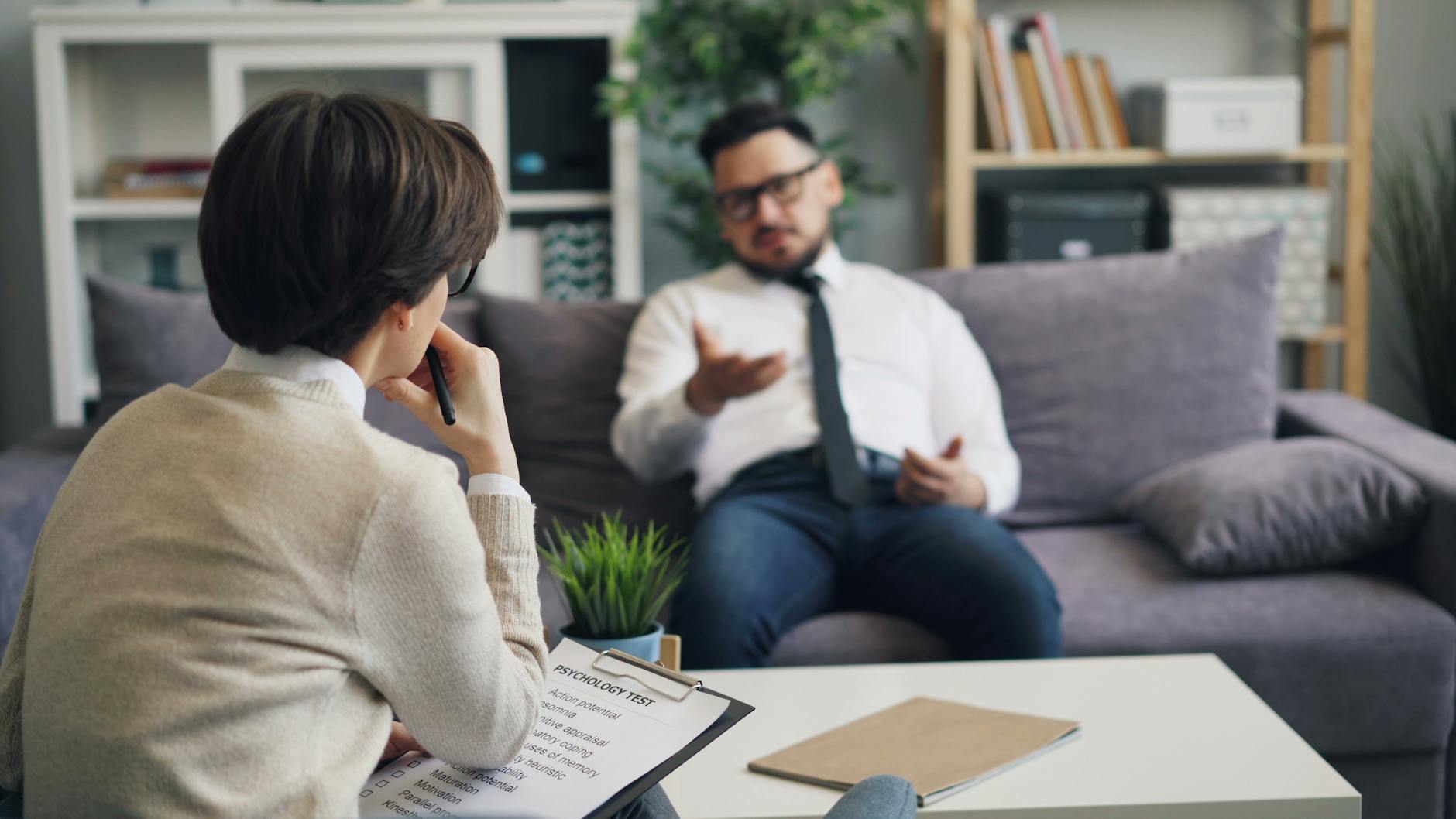 a man and woman sitting on a couch talking