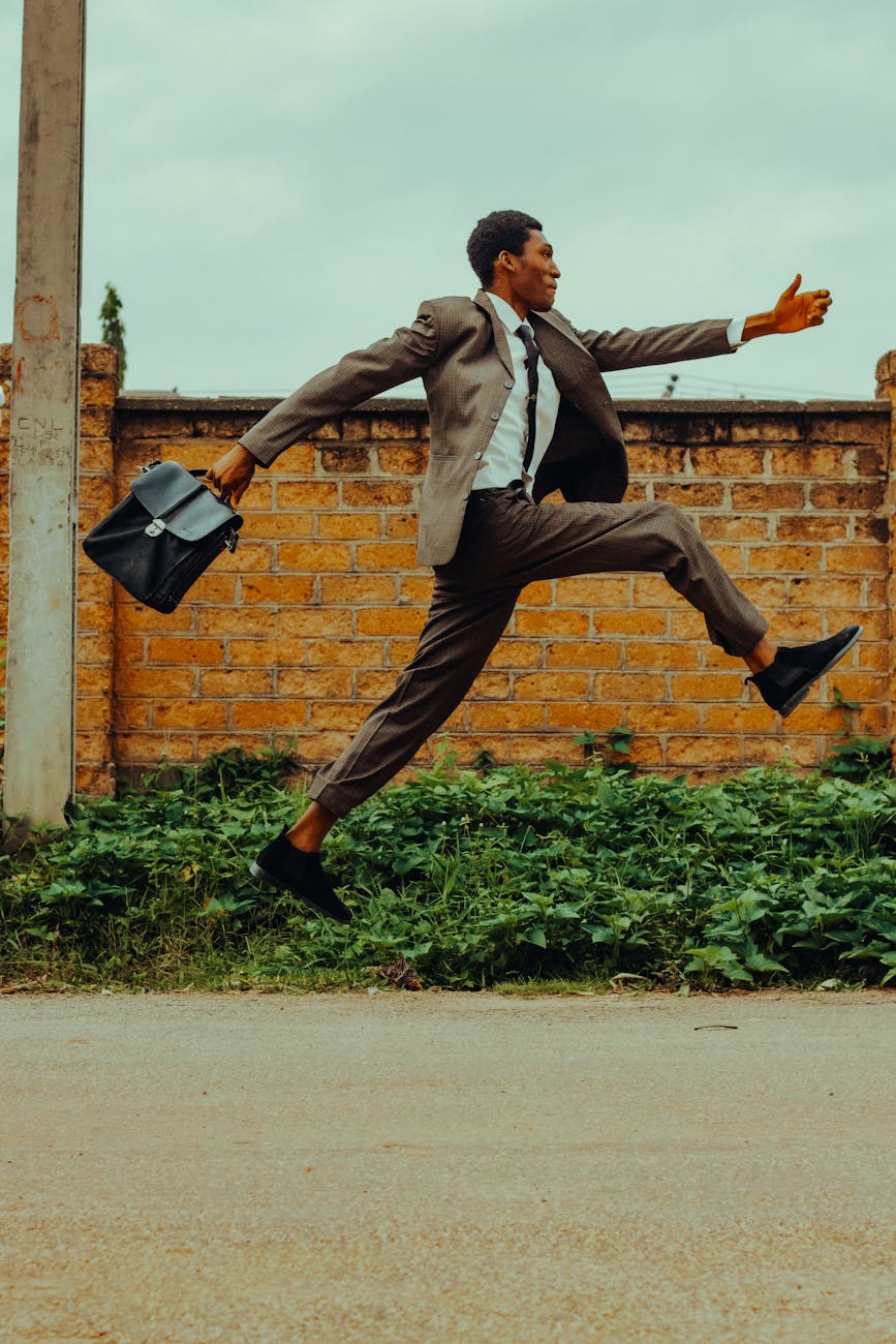 a man in a suit and tie is jumping in the air