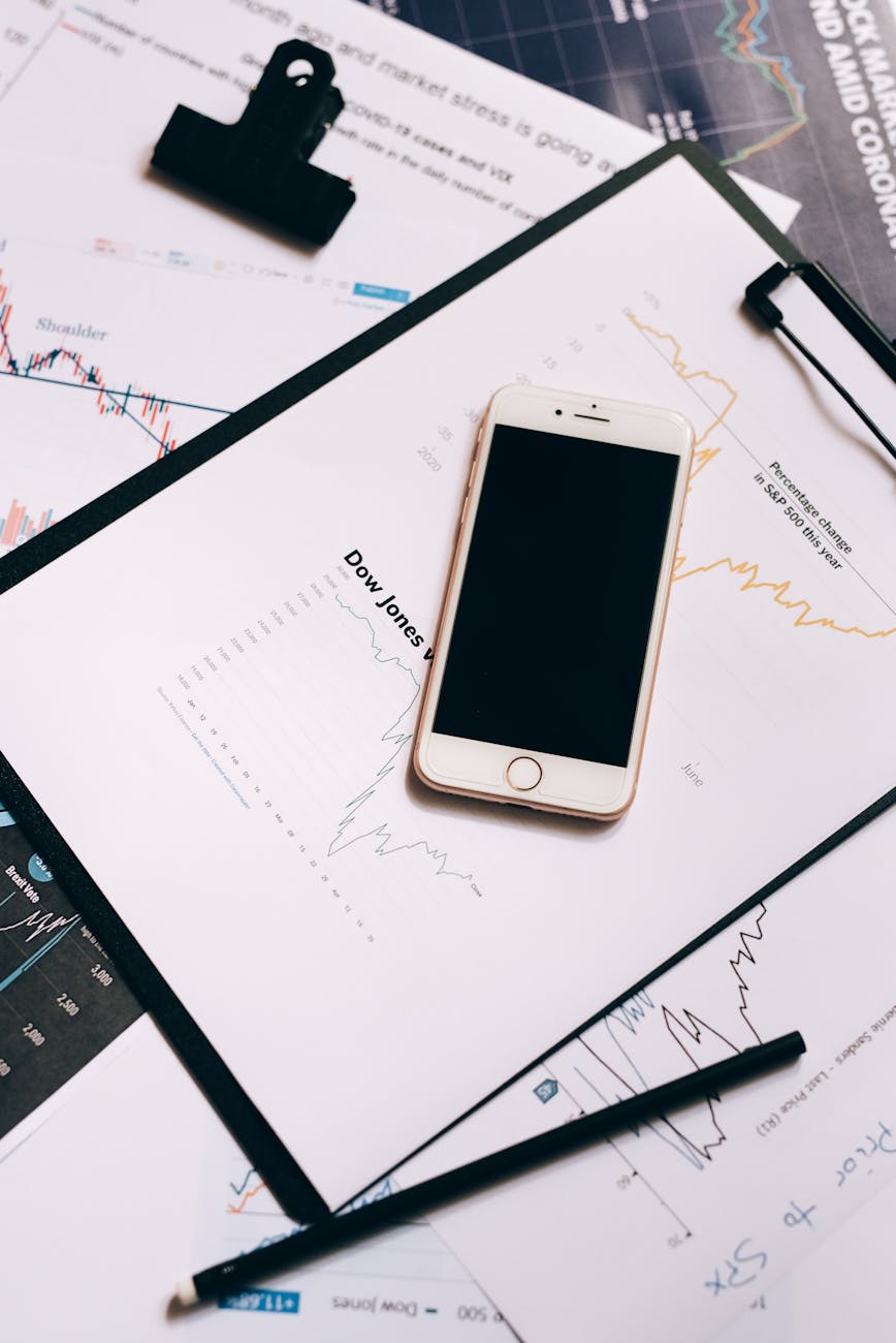 smartphone on clipboard with statistical data